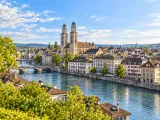 Illustration of Grossmünster and Zürich old town across the Limmat from Lindenhof