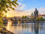 Illustration of Charles Bridge from the Kampa riverbank at dawn
