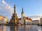 Illustration of Horní náměstí after rain with Holy Trinity Column and Town Hall