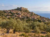 Illustration of Molyvos on Lesvos viewed across an olive grove