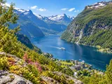 Illustration of Geirangerfjord-style elevated view with village, ferry and waterfalls