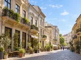 Illustration of Historic architecture along a cobbled street in Bucharest Old Town; representative Lipscani district, no exact building claimed.